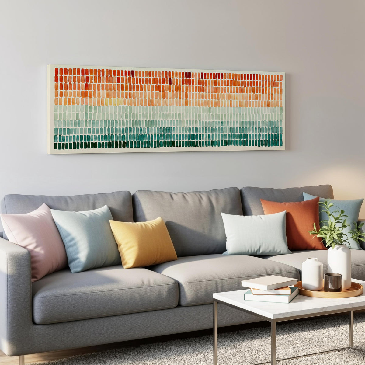 Brushmarks fading from orange to teal panoramic canvas print above a grey sofa in a living room