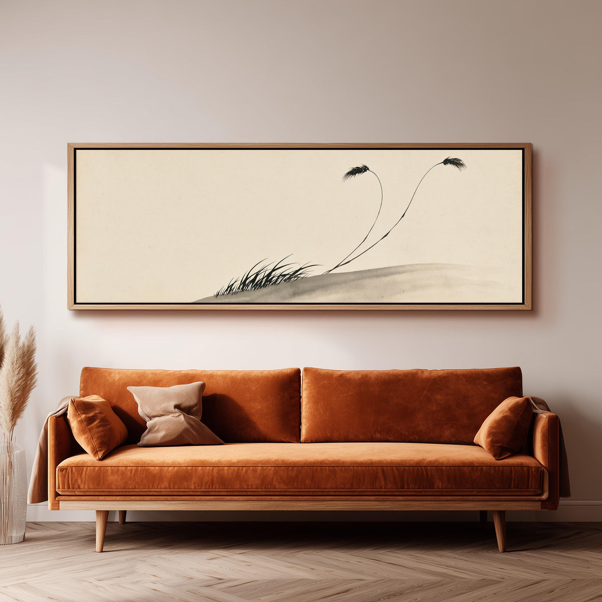 Two birds perched on bending ink reeds panoramic canvas print above a sofa in a living room