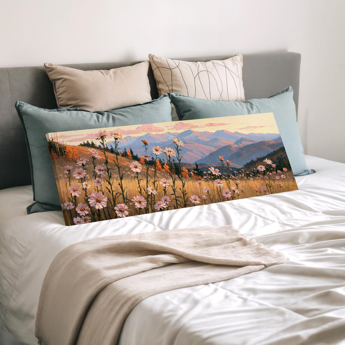 Wildflower meadow with mountains wide panoramic canvas print laid on a bed to show its size