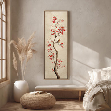 a serene bedroom scene with a large painting of a tree with red flowers hanging on the wall. The painting is framed in a white frame and is the focal point of the room. The room features a bed with white linens, a wicker ottoman, and a potted plant. The overall color scheme of the room is neutral, with the red flowers on the painting adding a pop of color.