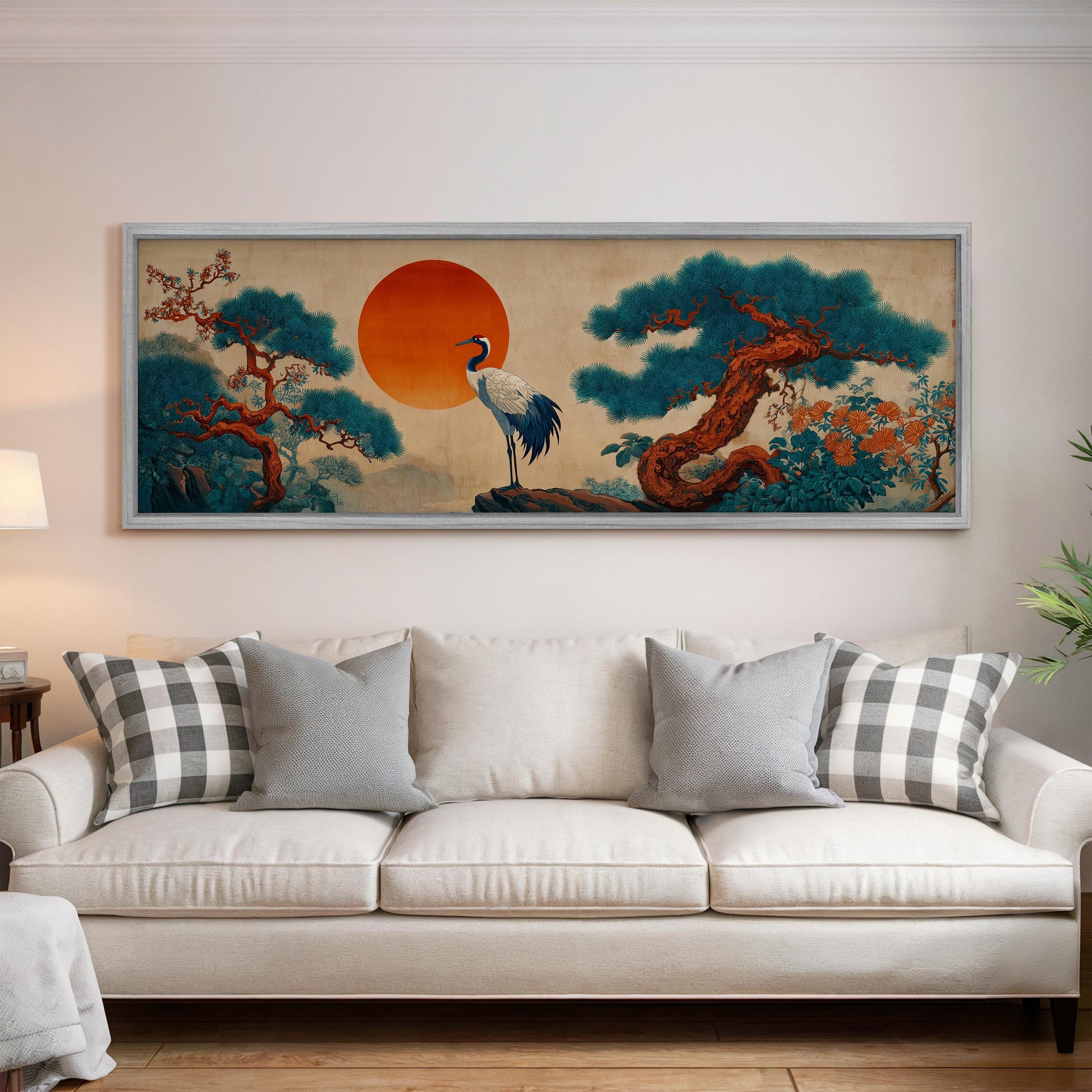 a large, framed painting of a crane standing on a rock, surrounded by a landscape with trees and a large orange sun in the sky.