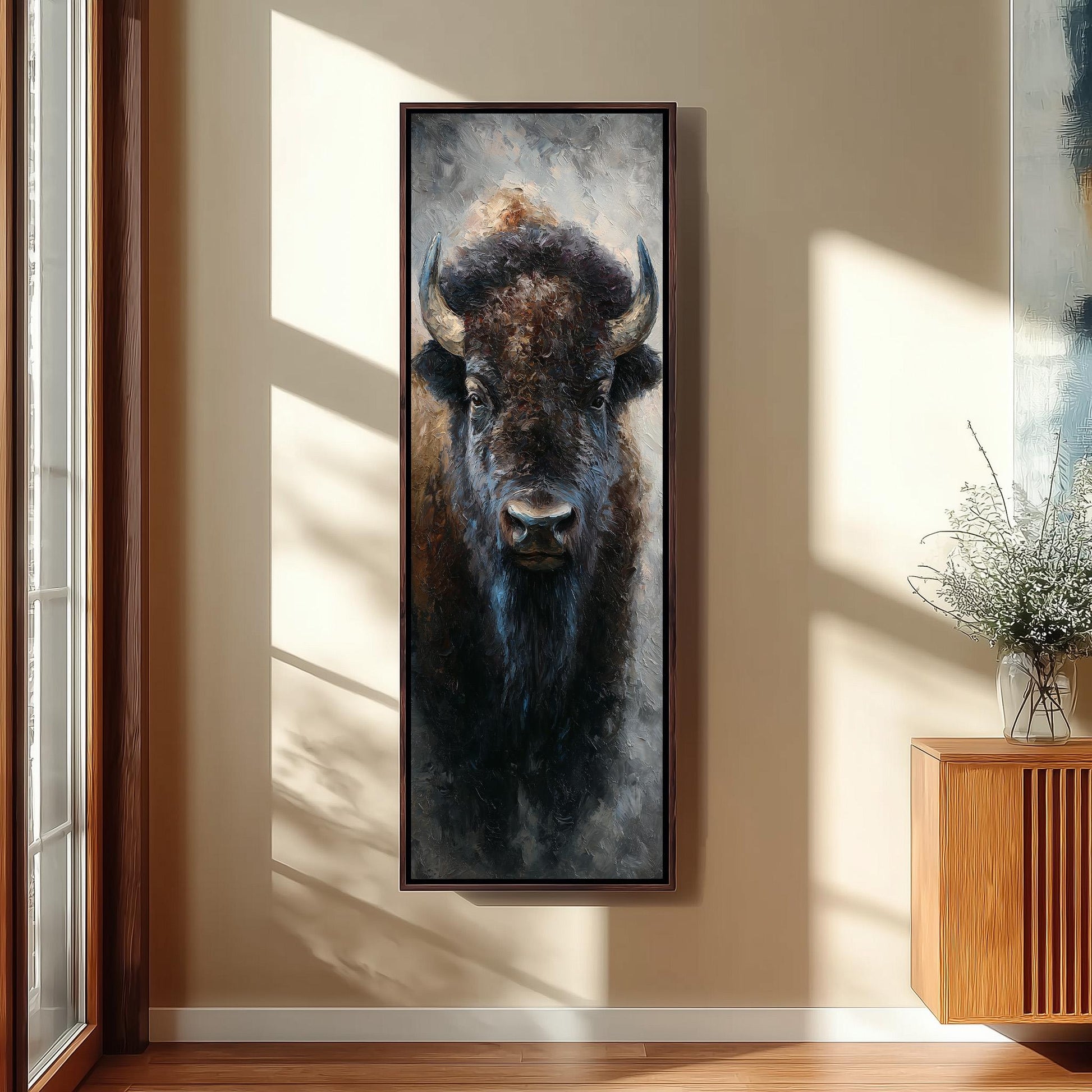 a large painting of a buffalo's head hanging on a wall in a room with a wooden cabinet below it.