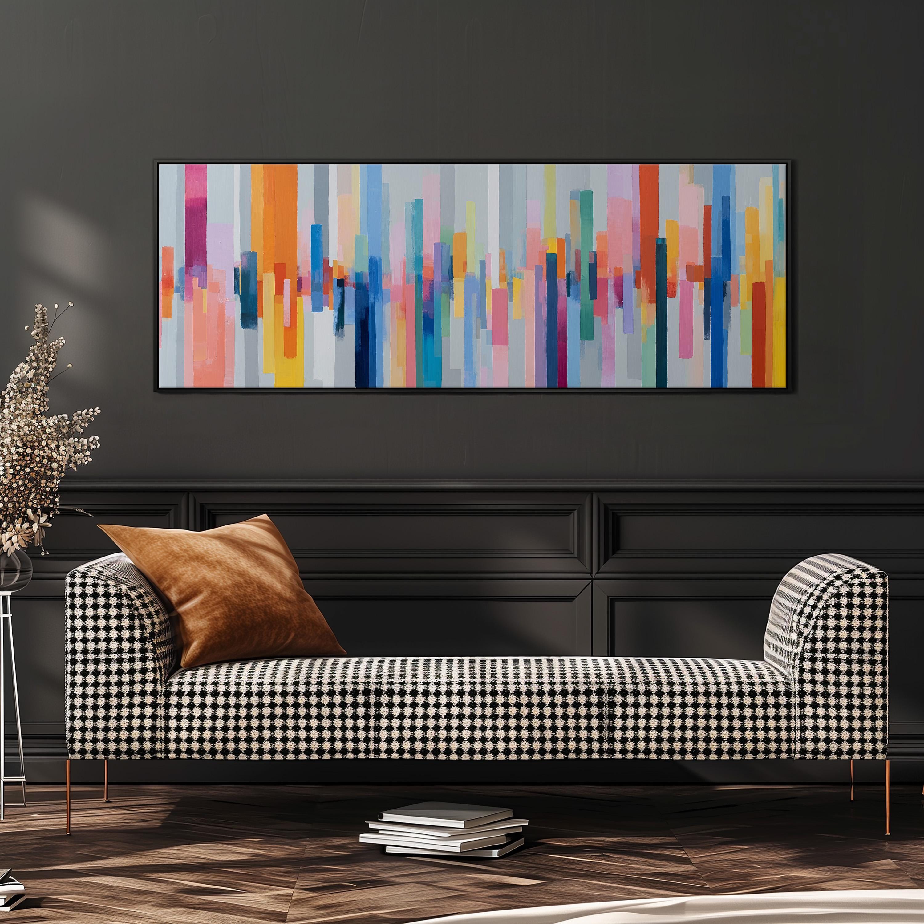 a modern living room with a black and white checkered sofa, a stack of books, and a large abstract painting hanging on the wall above the sofa.