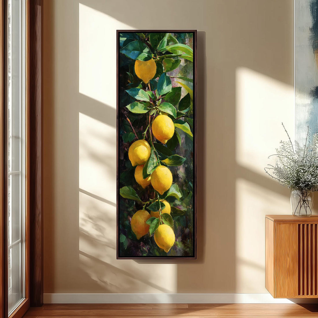 A framed painting of a lemon tree hangs on a wall, with several lemons hanging from the branches.
