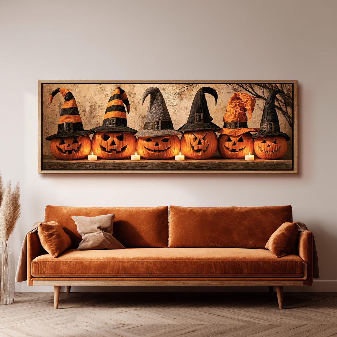 Jack-o'-lanterns wearing witch hats by candlelight long horizontal canvas print above a sofa in a living room