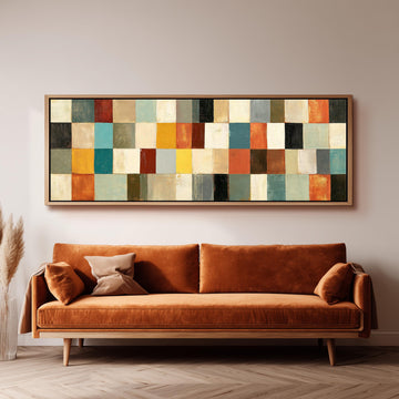 Colorful checkerboard mosaic grid long horizontal canvas print above a sofa in a living room