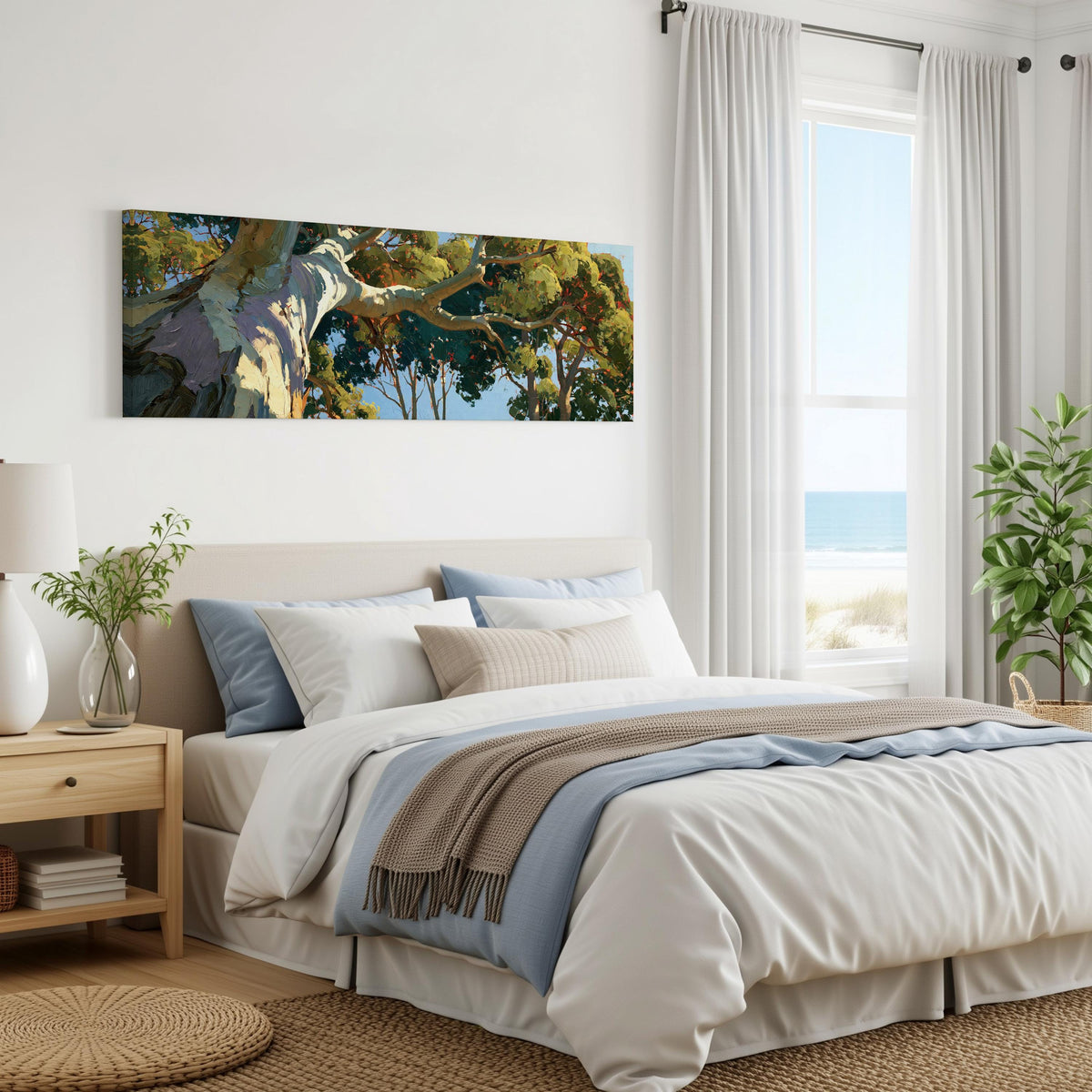 Sunlit eucalyptus trunk and branches panoramic canvas print above a bed in a coastal bedroom