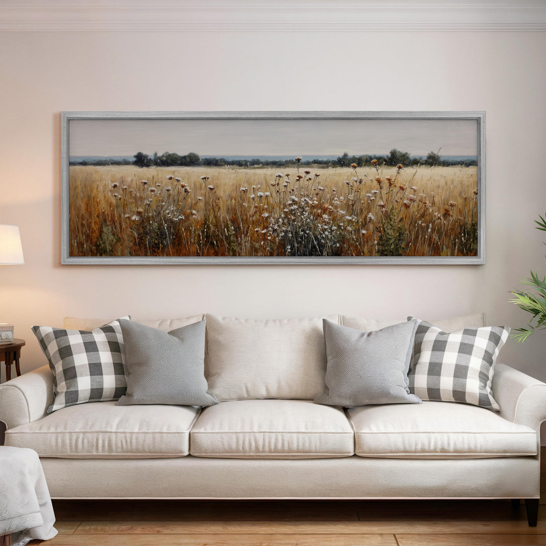a dining room with a large painting of a field of flowers hanging on the wall above a wooden dining table with four chairs. The table is set with a bowl of fruit and a vase of flowers, creating a cozy and inviting atmosphere.