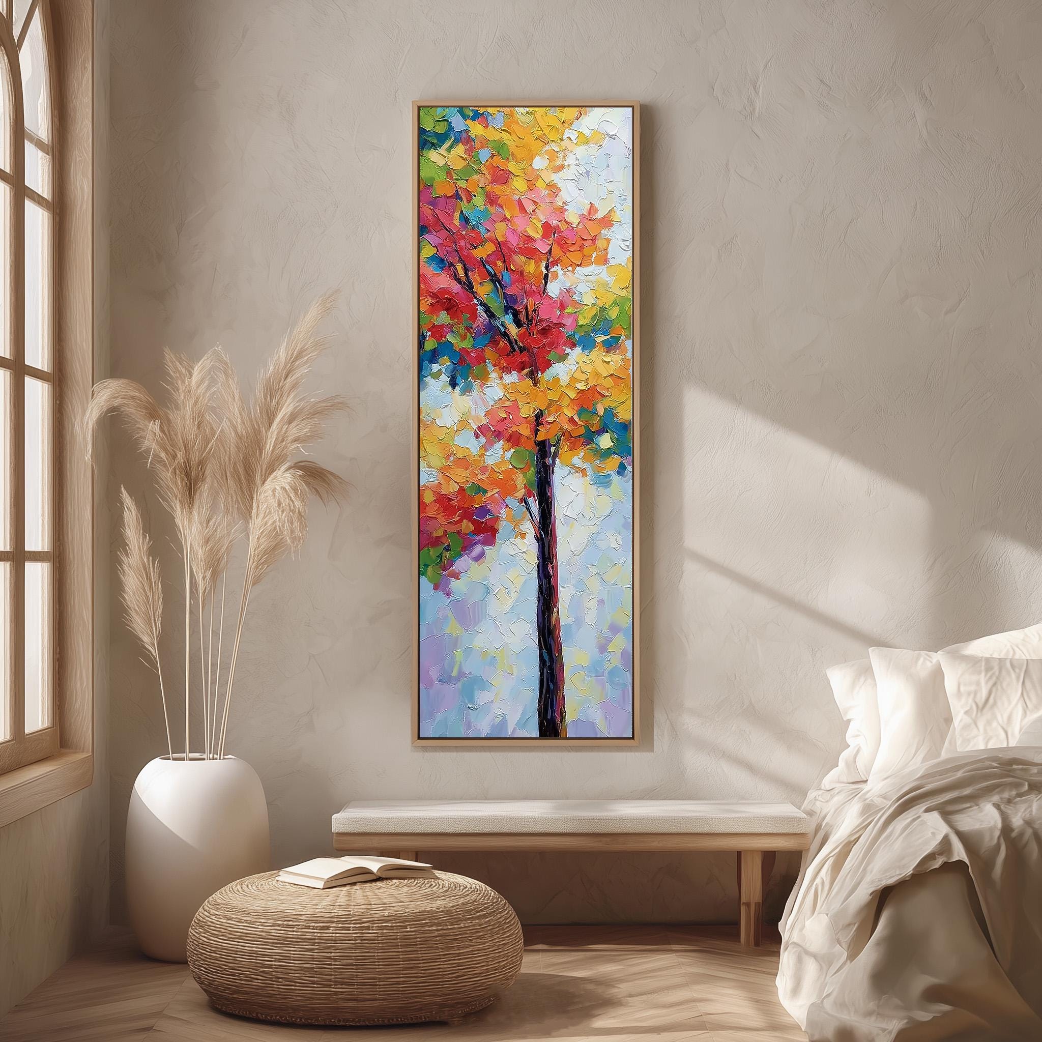 a large, colorful painting of a tree hanging on a wall in a room with a wooden floor and a white bed.