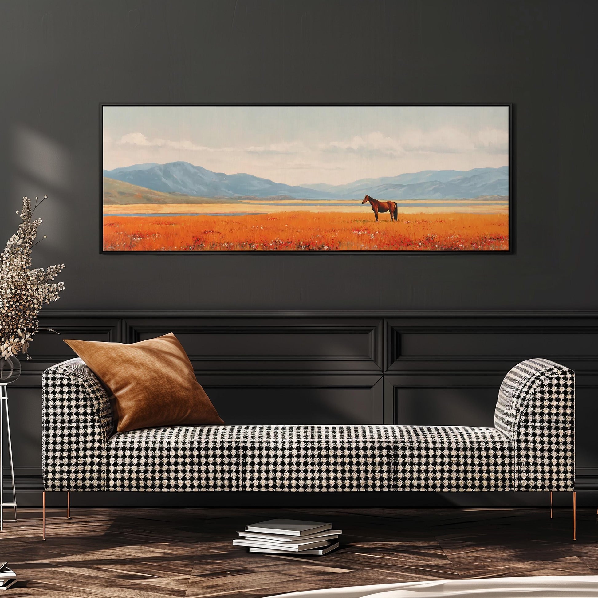 a large painting of a horse in a field, hanging on a wall above a black and white checkered sofa.