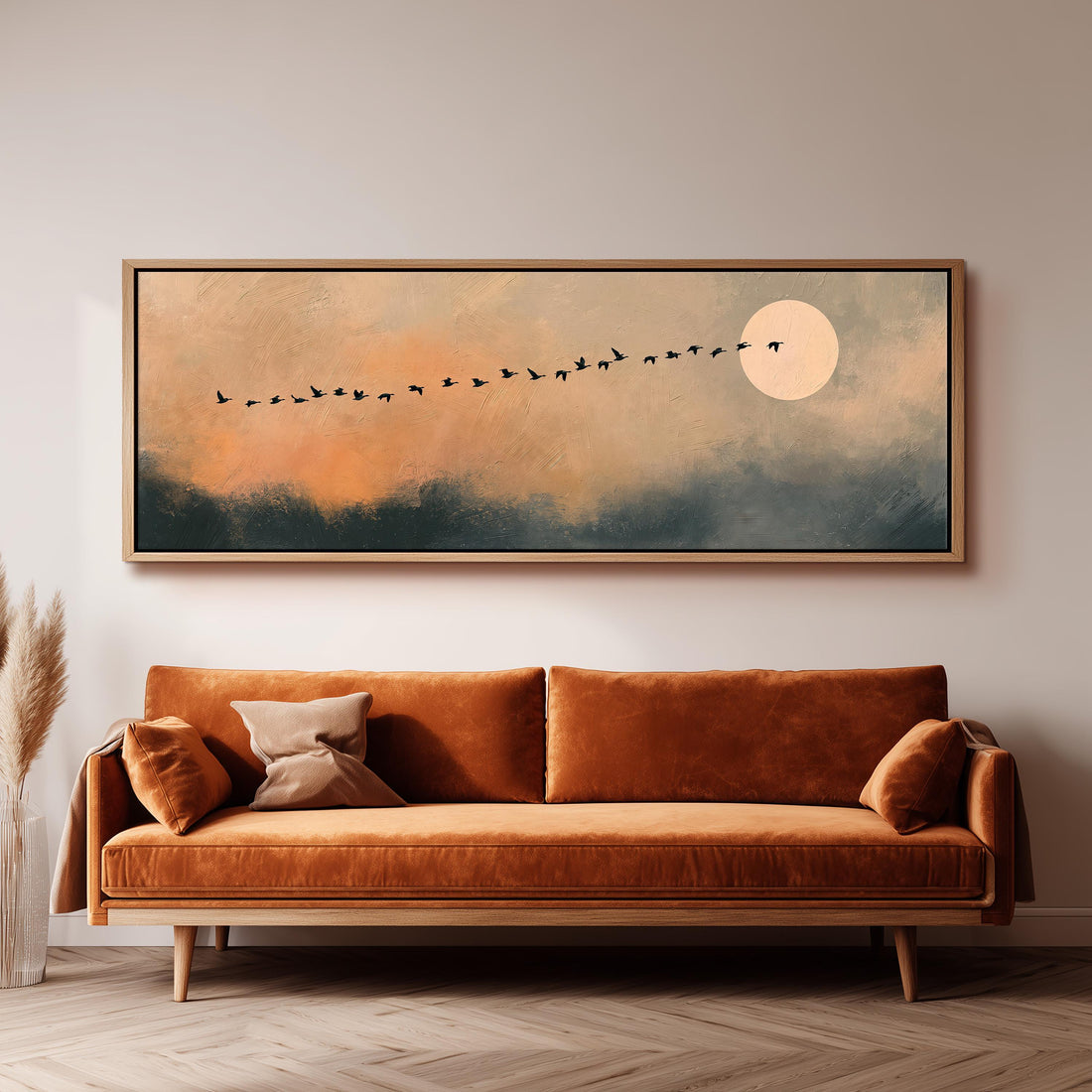 Migrating birds passing a moon at peach dusk long horizontal canvas print above a sofa in a living room
