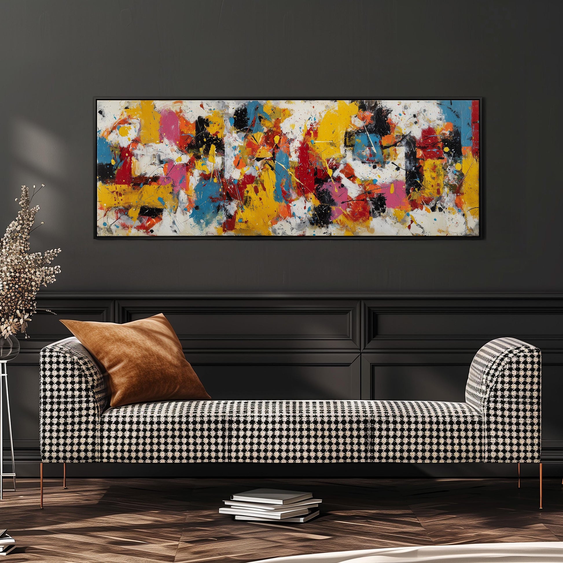 a modern living room with a black and white checkered sofa, a stack of books, and a large abstract painting hanging on the wall above the sofa.