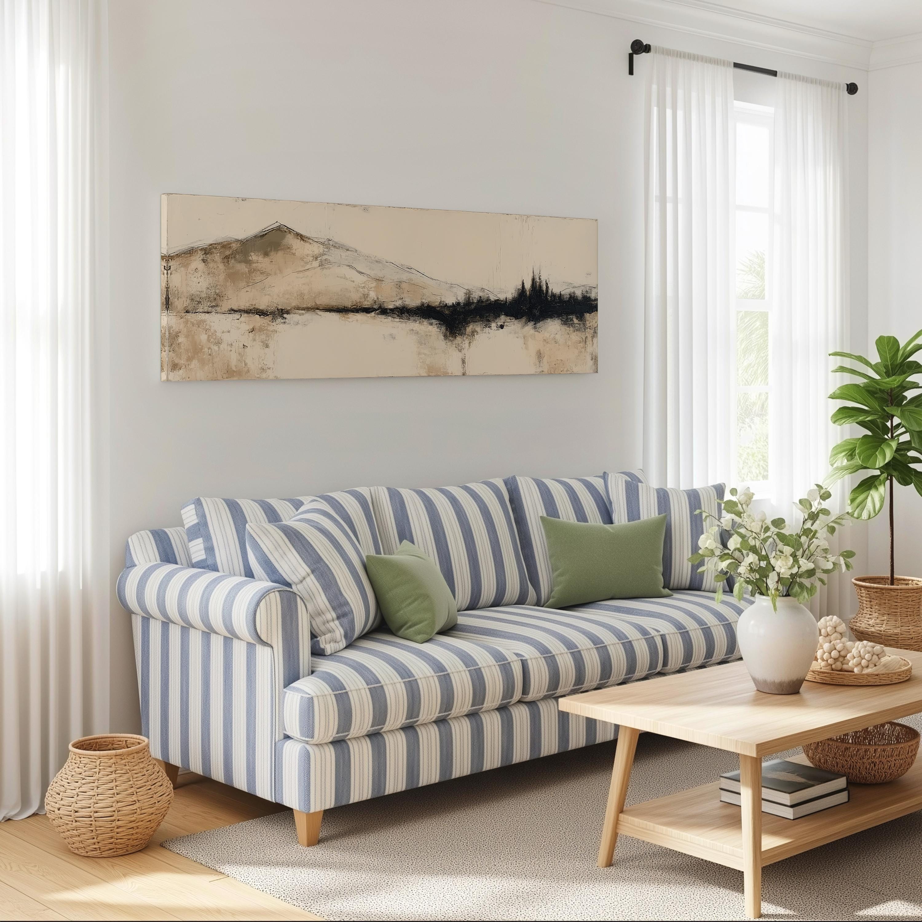 a cozy living room with a striped blue and white sofa, a wooden coffee table, and a large window with white curtains. Above the sofa, there is a framed landscape painting depicting a mountain scene.