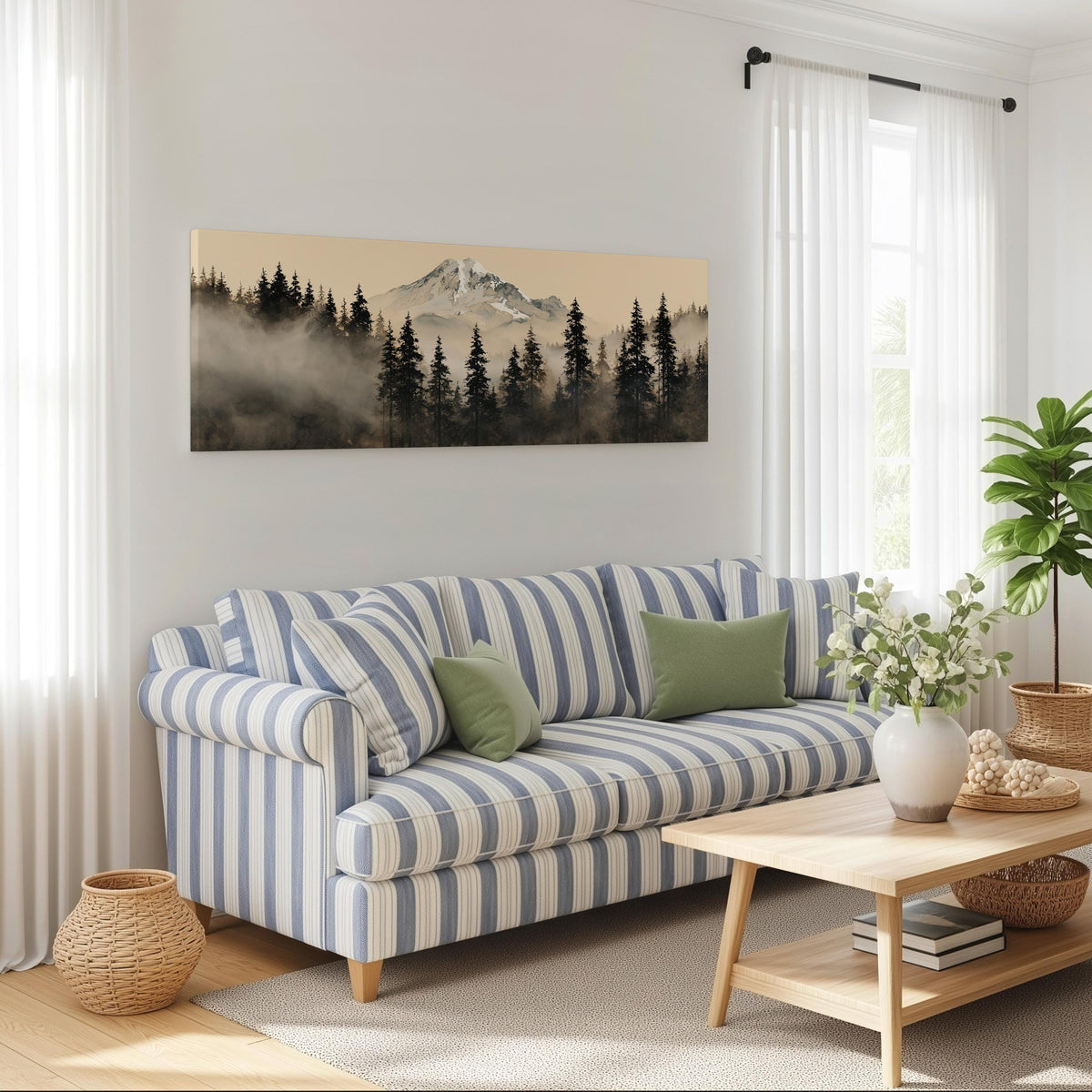 Foggy pine forest below a snowy mountain long horizontal canvas print above a striped sofa in a coastal living room