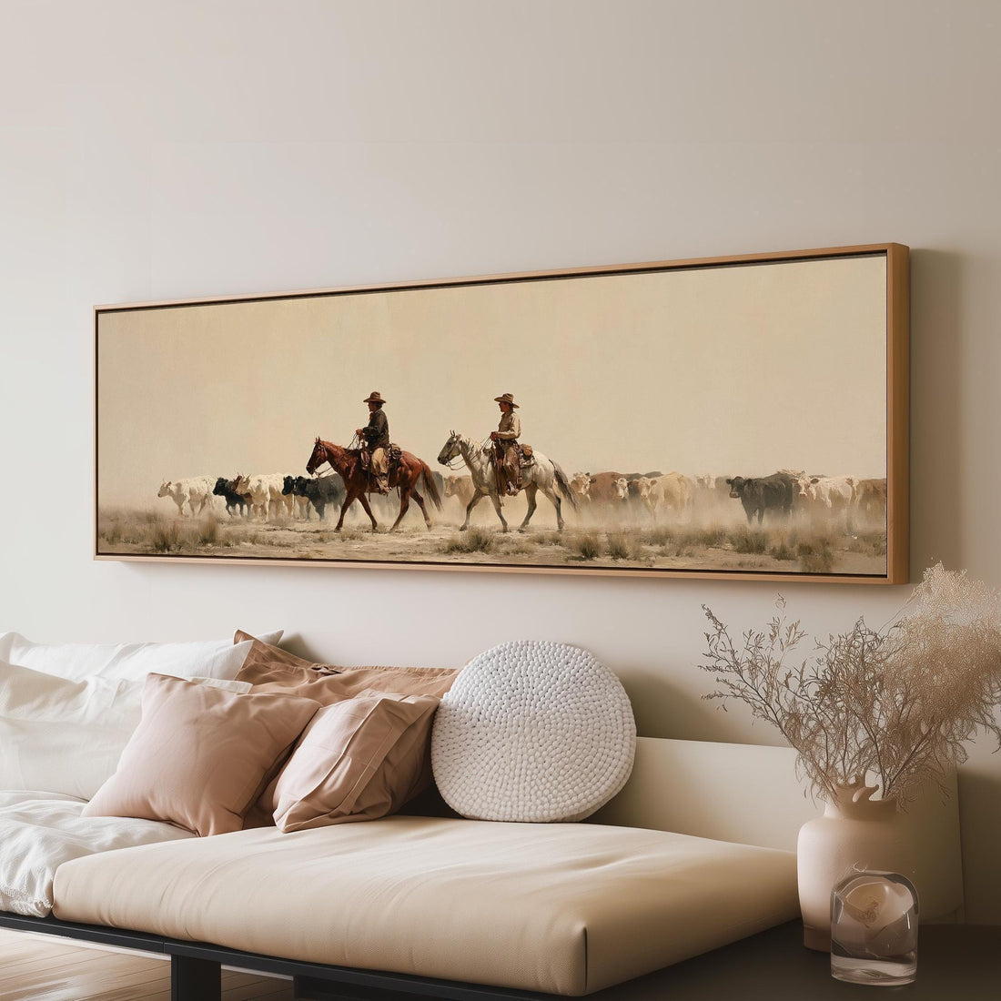 Cowboys herding cattle across a dusty plain long horizontal canvas print above a sofa in a living room