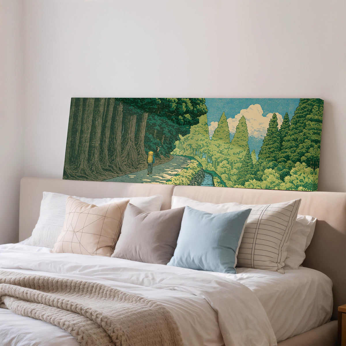 Hiker on a forest trail wide panoramic canvas print above a bed in a bedroom