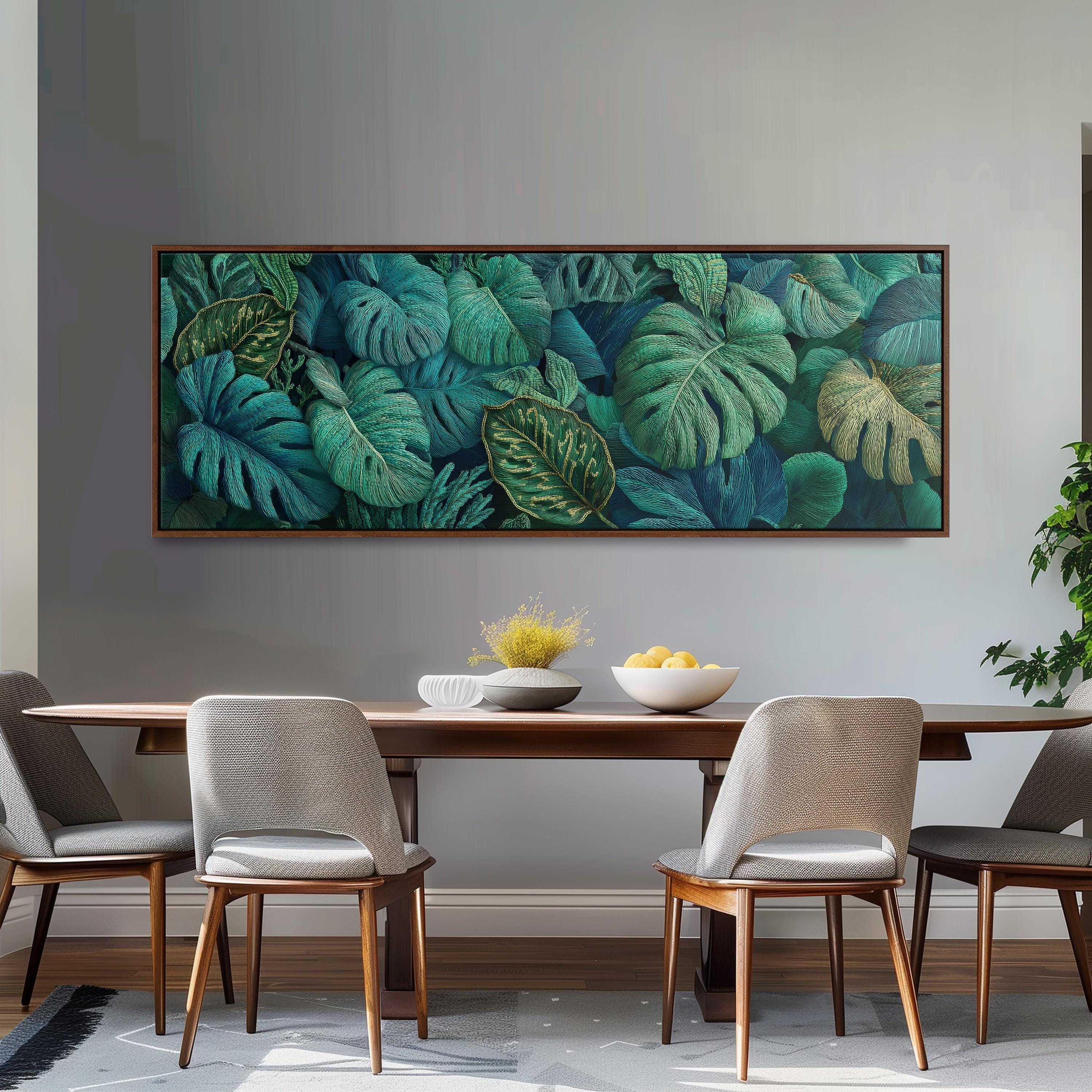 a dining room with a large painting of tropical leaves hanging on the wall above a wooden dining table with four chairs. The table is set with a bowl of fruit and a vase of flowers, creating a cozy and inviting atmosphere.