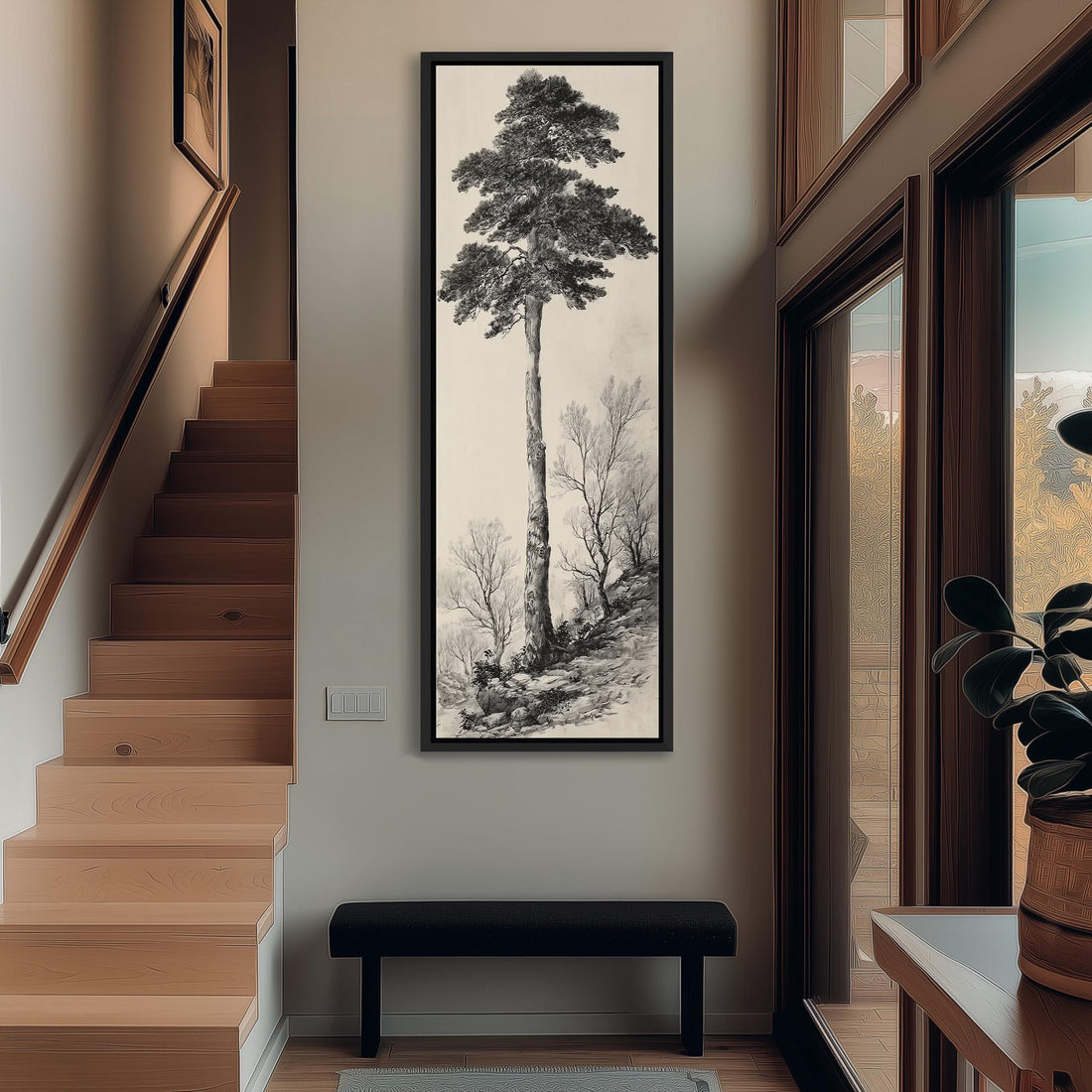 a large black and white painting of a tall tree hanging on a wall in a room with wooden furniture.