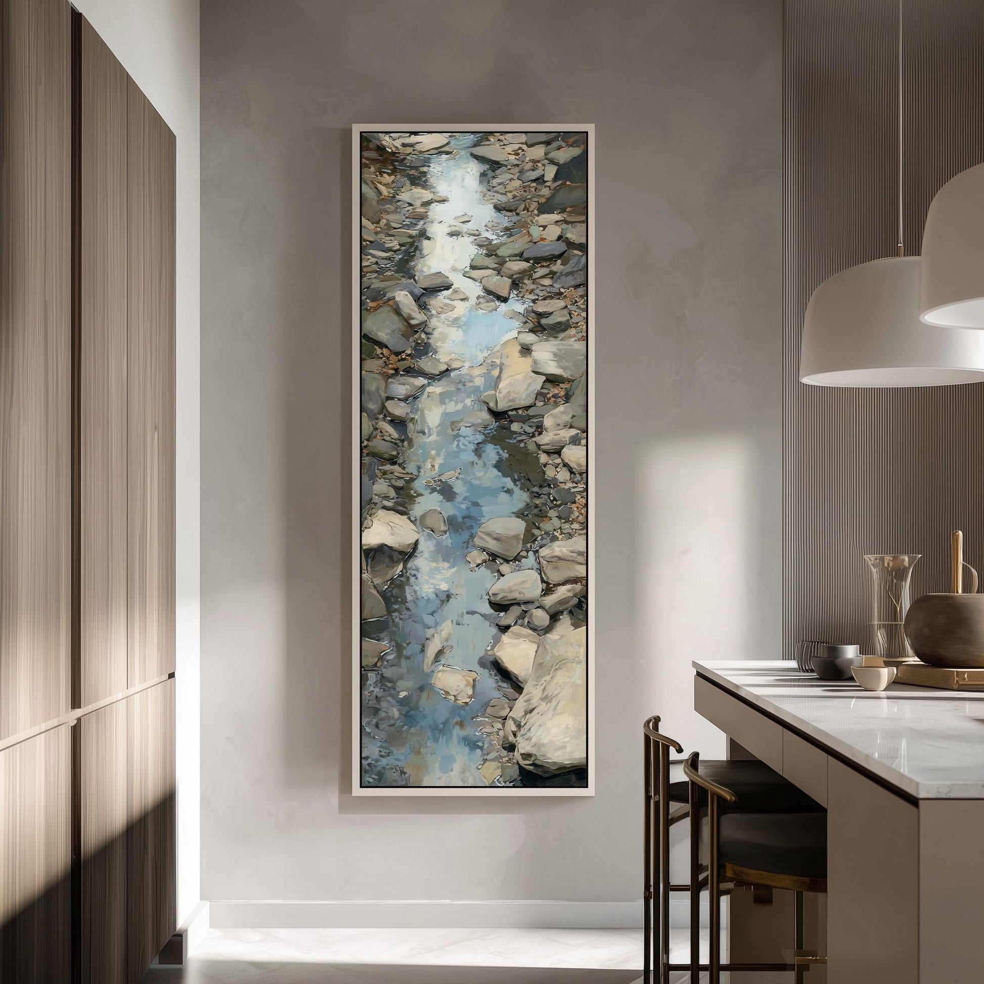 a large painting of a rocky stream or river, hanging on a wall in a modern kitchen.