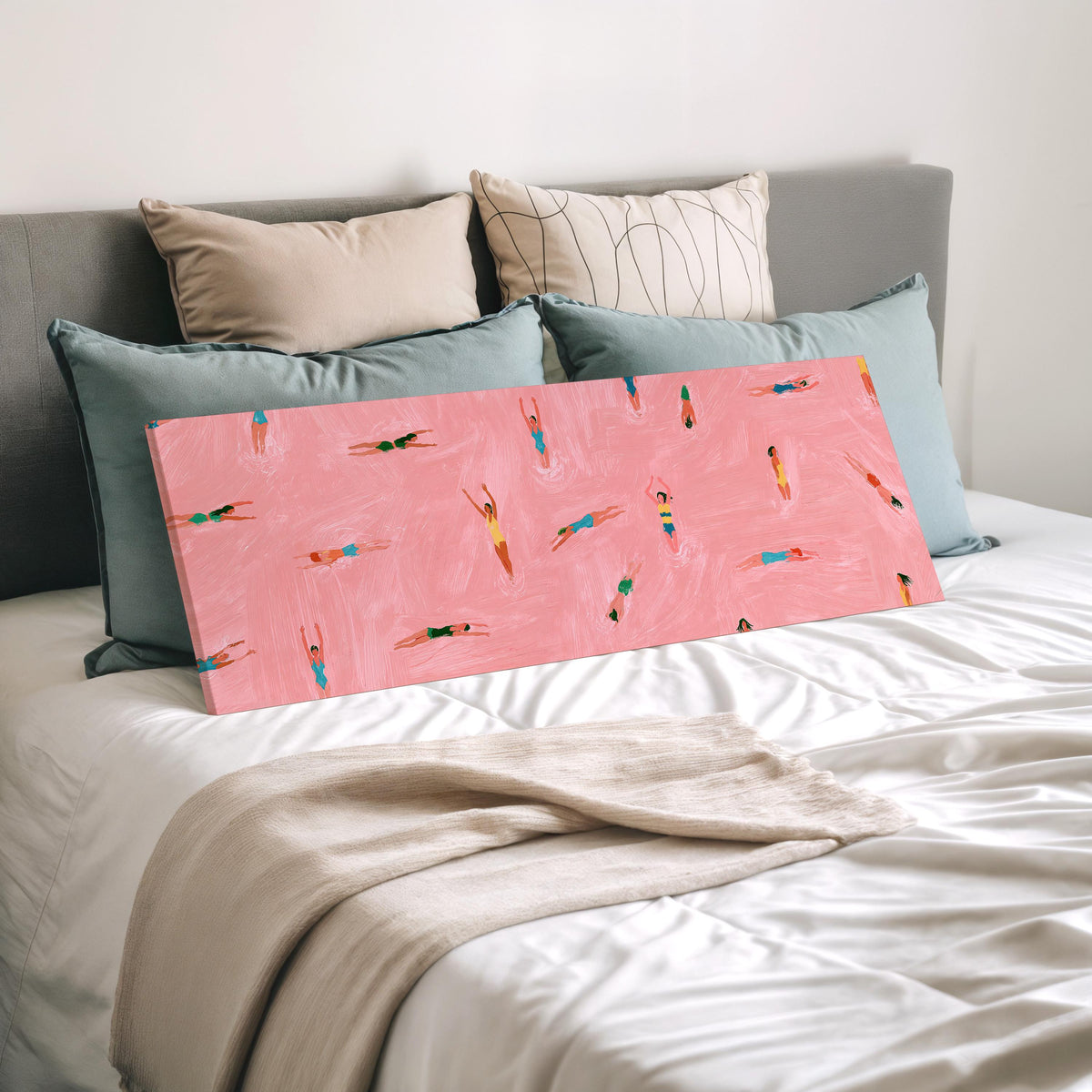Tiny swimmers in a pink pool from above wide panoramic canvas print laid on a bed to show its size