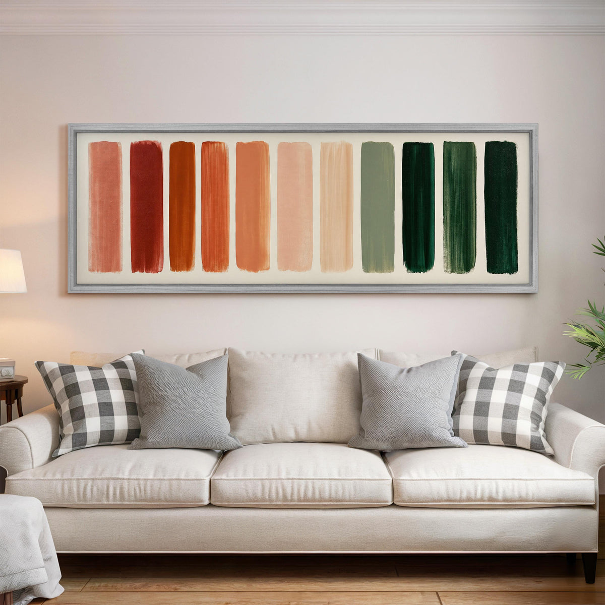 Brushed swatches from terracotta to forest green panoramic canvas print above a white sofa in a bright living room