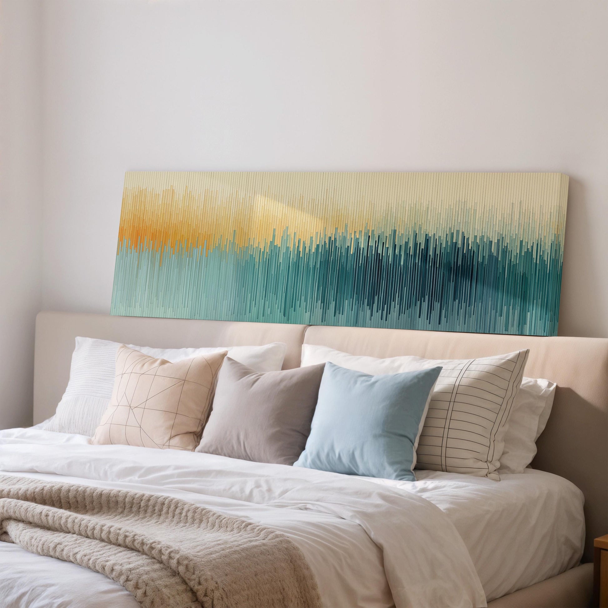 a cozy bedroom with a large bed adorned with white linens and a variety of colorful throw pillows. Above the bed, there is a large abstract painting with a gradient of colors, creating a vibrant and visually appealing focal point in the room.