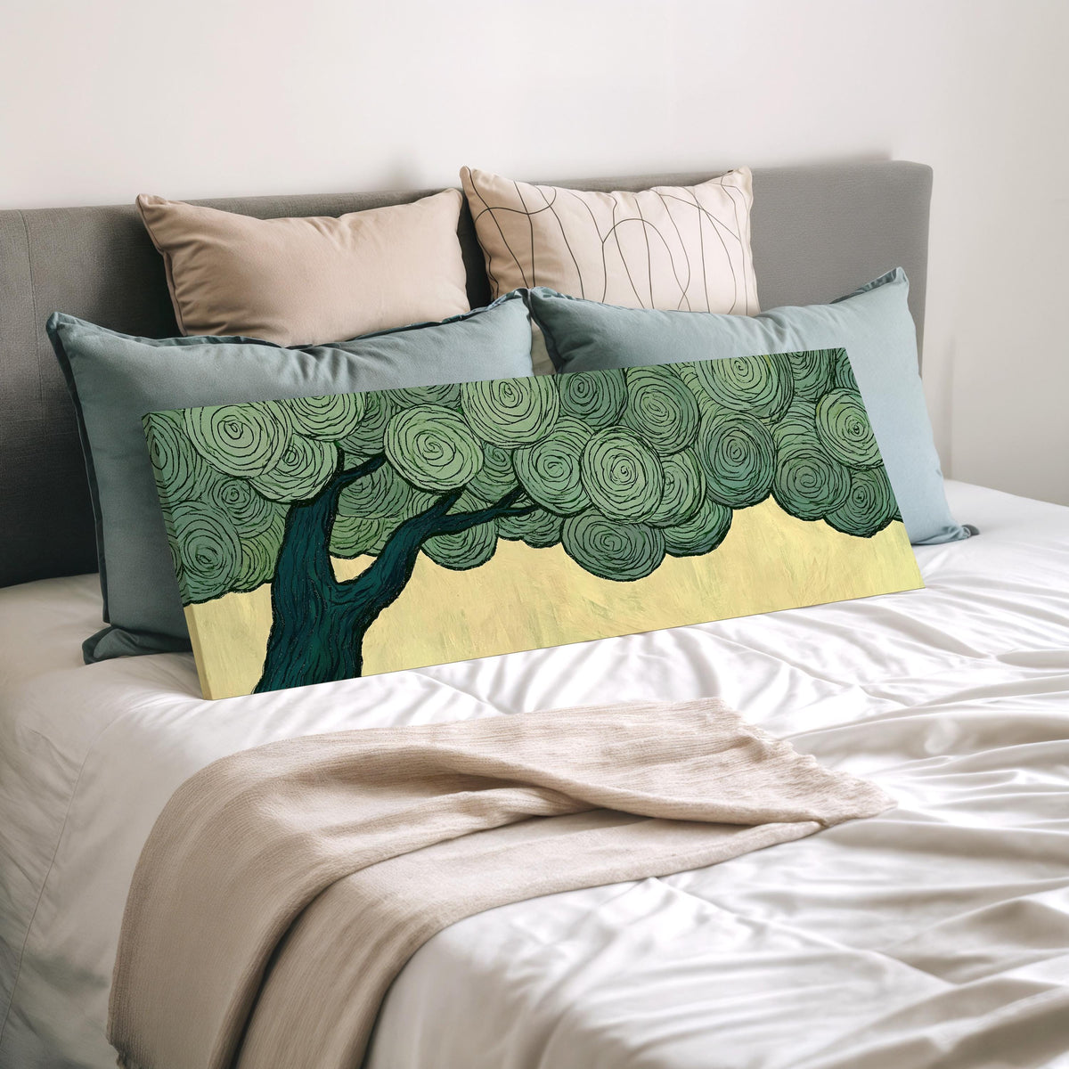 Tree with a swirling green canopy wide panoramic canvas print laid on a bed to show its size