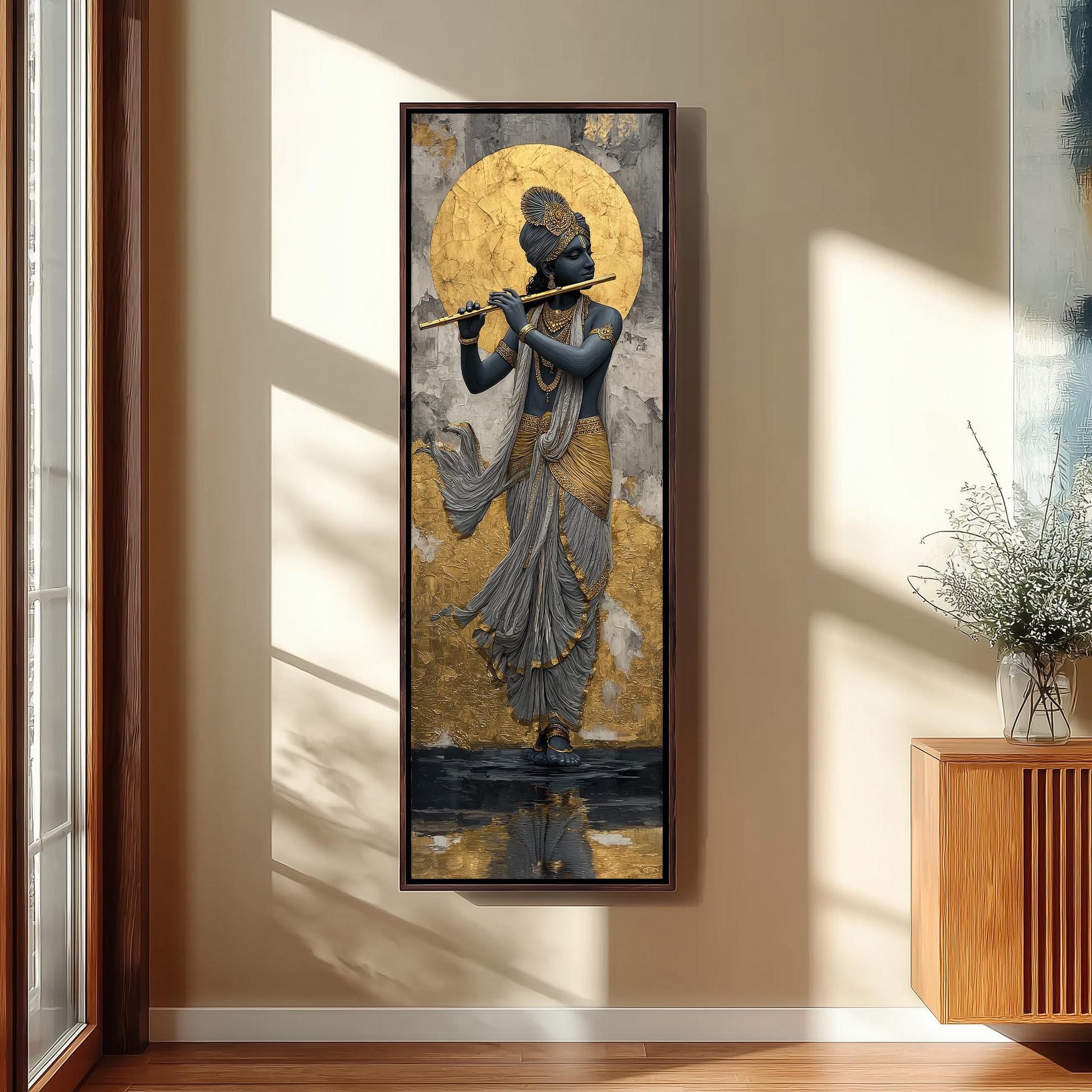 a large framed painting of a person playing a flute, hanging on a wall in a room with a wooden cabinet and a vase of flowers.