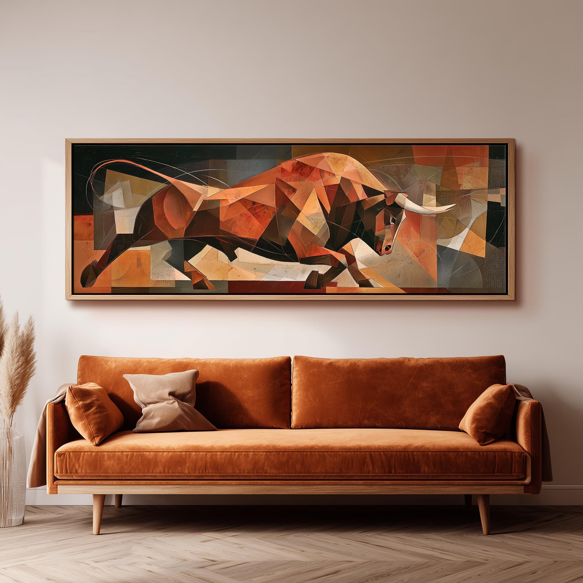 a large abstract painting of a bull, which is hanging on a wall above a brown sofa.