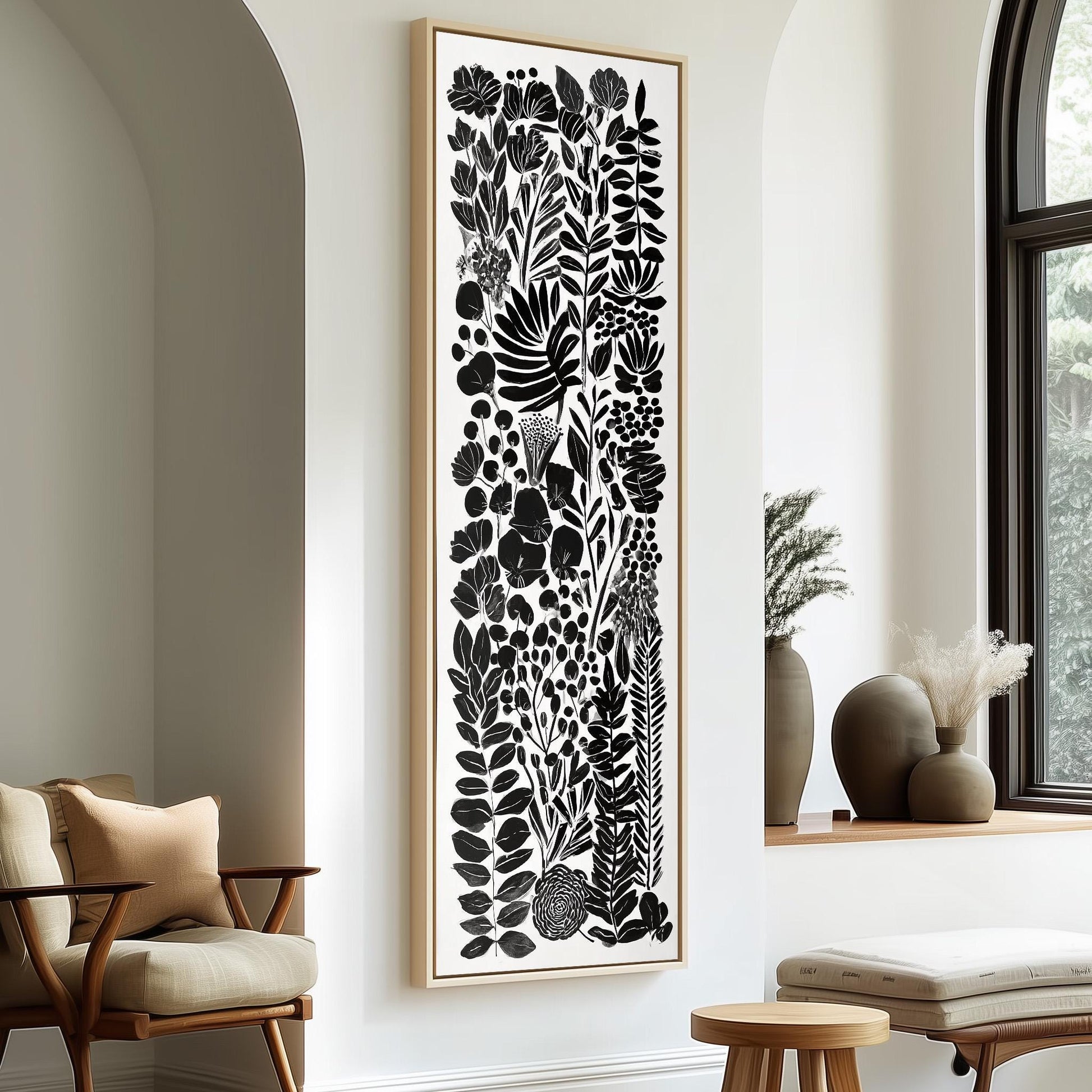 a modern living room with a large black and white abstract artwork hanging on the wall, complemented by a wooden chair and a small table.
