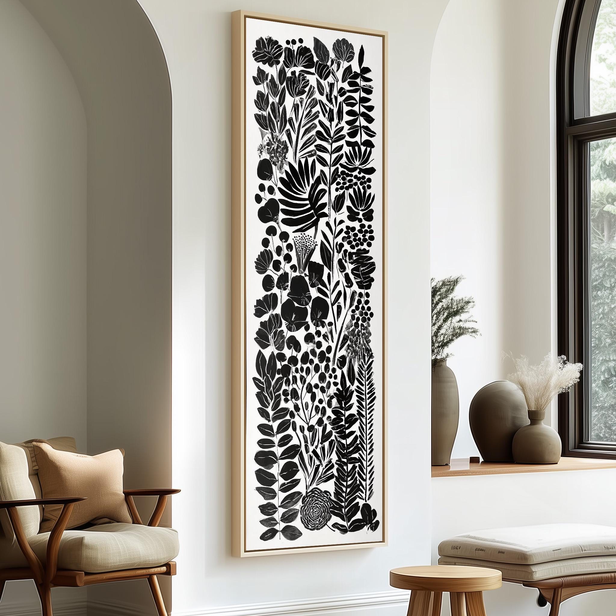 a modern living room with a large black and white abstract artwork hanging on the wall, complemented by a wooden chair and a small table.