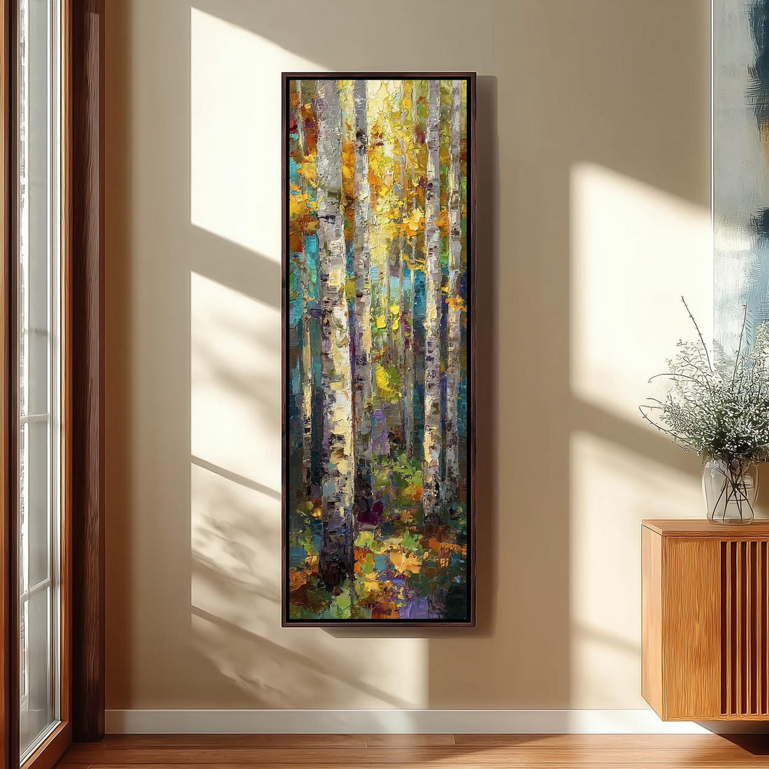a large, colorful painting of a forest scene hanging on a wall in a room with a wooden floor and a window.