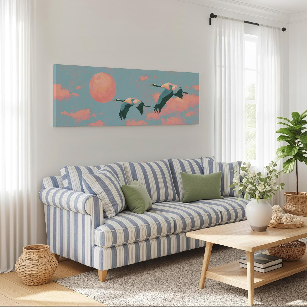 Two cranes flying at sunset long horizontal canvas print above a striped sofa in a coastal living room