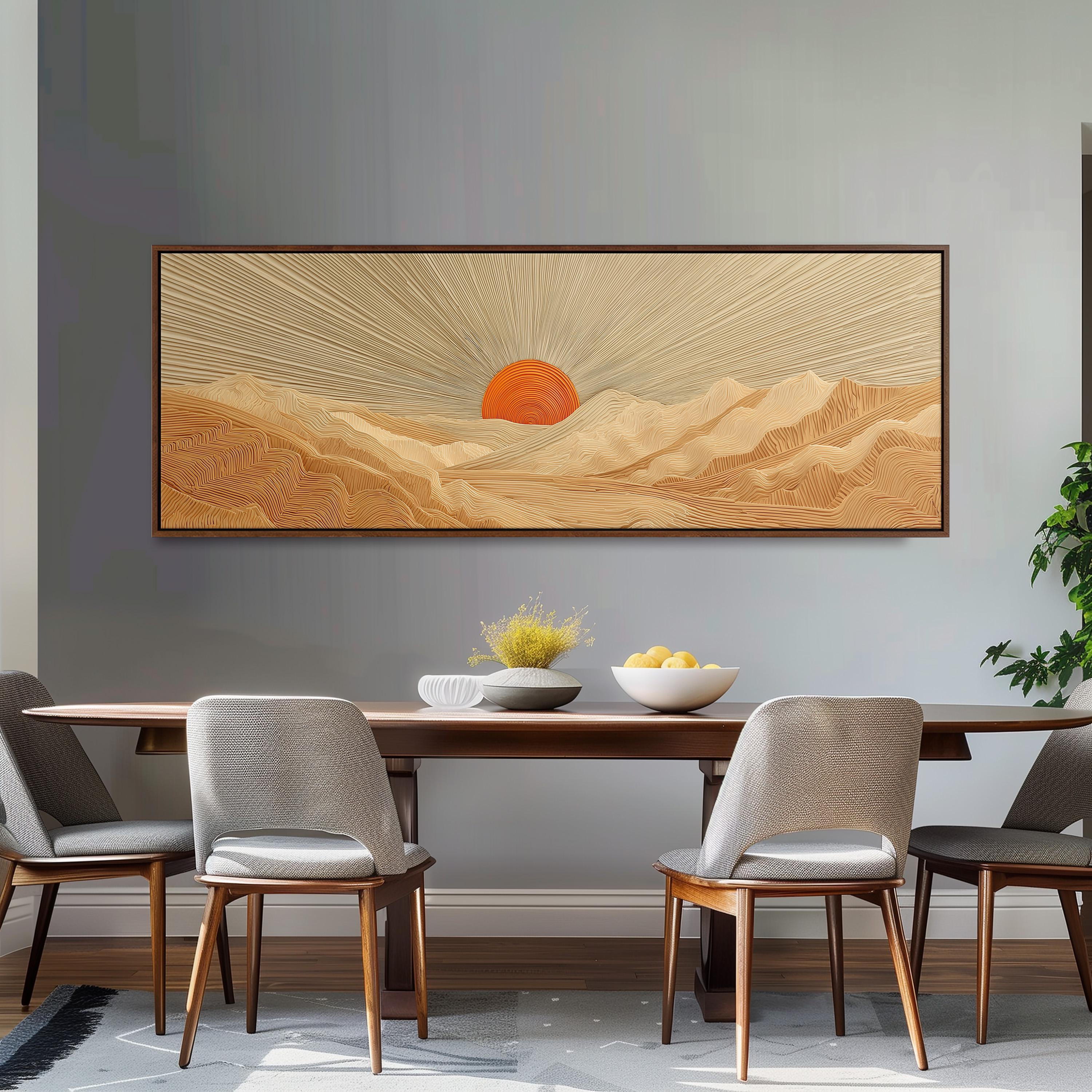 a dining room with a large wooden table and four chairs. Above the table, there is a large framed artwork depicting a desert landscape with a sun in the background. The artwork is hanging on a gray wall, and the table is set with a bowl of fruit and a vase of flowers.