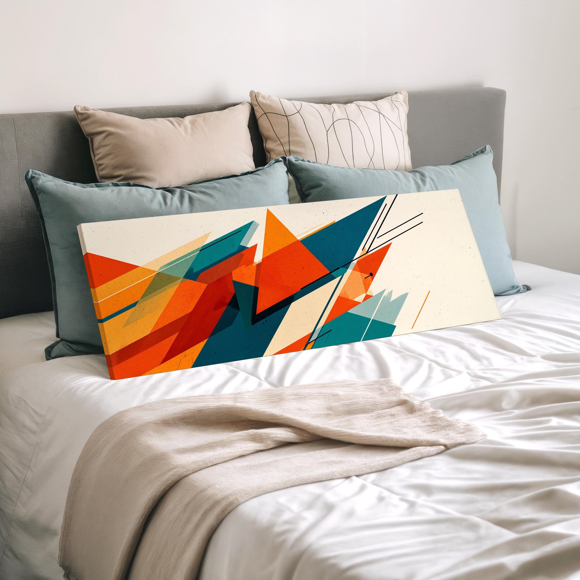 a modern abstract artwork displayed on a bed with a white comforter and pillows.