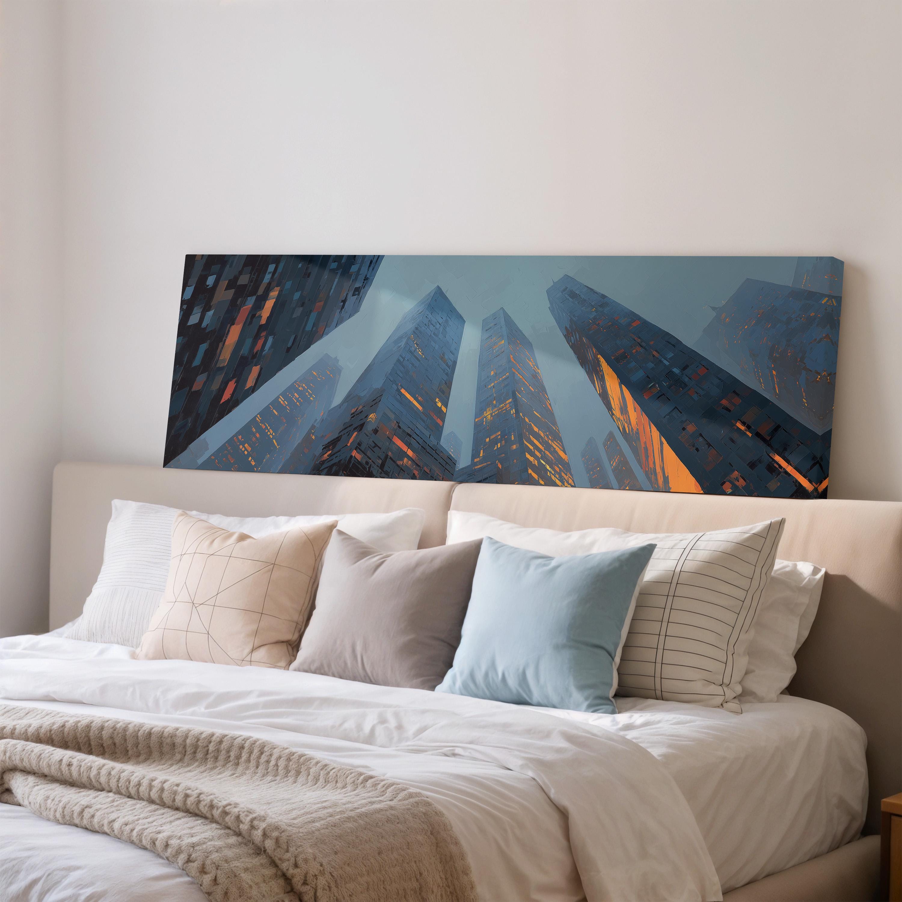 a large, colorful painting of tall buildings with orange lights on the wall above a bed with white linens and pillows.