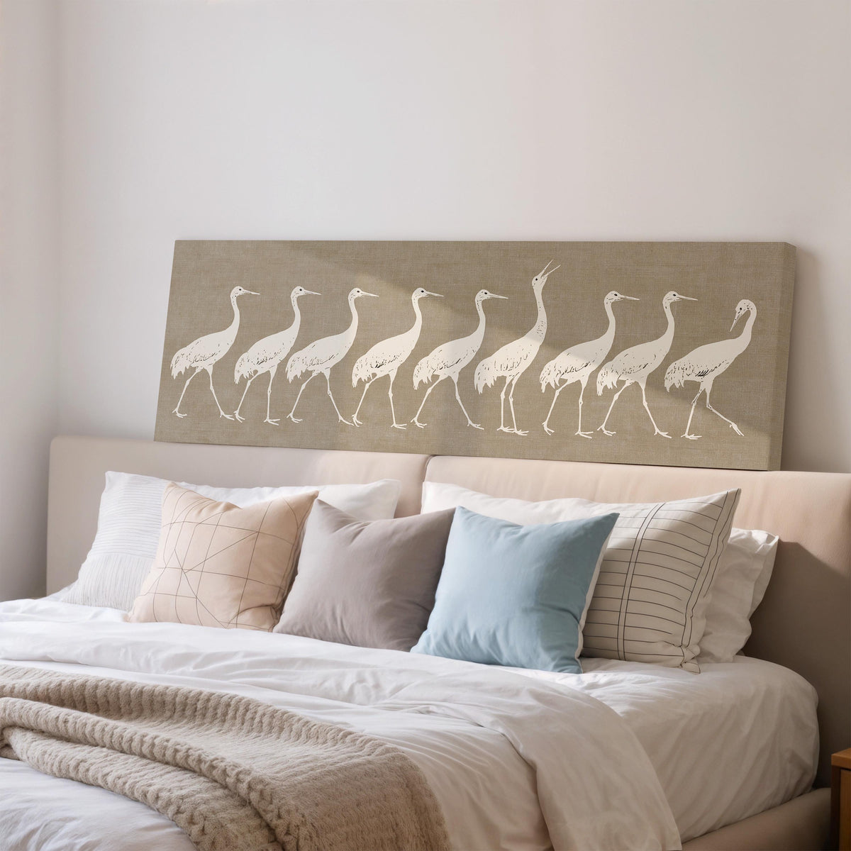 Procession of white cranes on linen wide panoramic canvas print above a bed in a bedroom