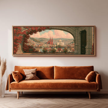 Old world city view through an archway long horizontal canvas print above a sofa in a living room