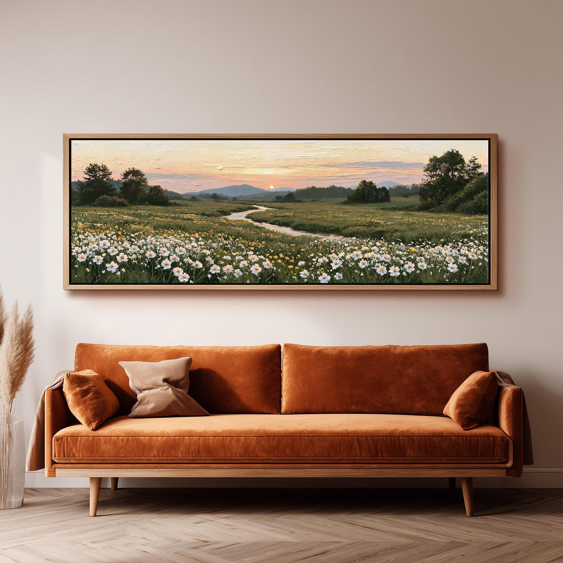 Daisy meadow with a winding stream at sunset long horizontal canvas print above a sofa in a living room
