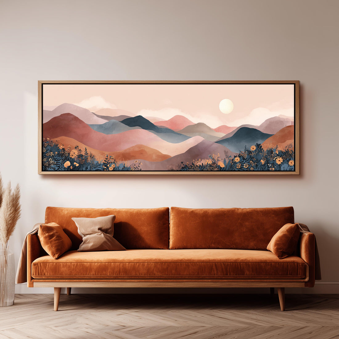 a large, rectangular painting of a mountainous landscape hanging on a wall above a brown sofa.