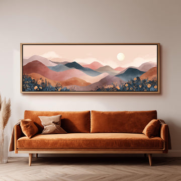 a large, rectangular painting of a mountainous landscape hanging on a wall above a brown sofa.