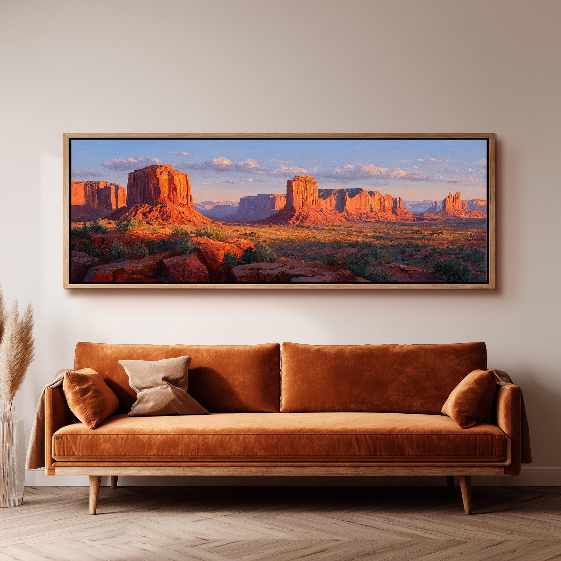 a large, framed painting of a desert landscape with towering red rock formations and a clear blue sky.