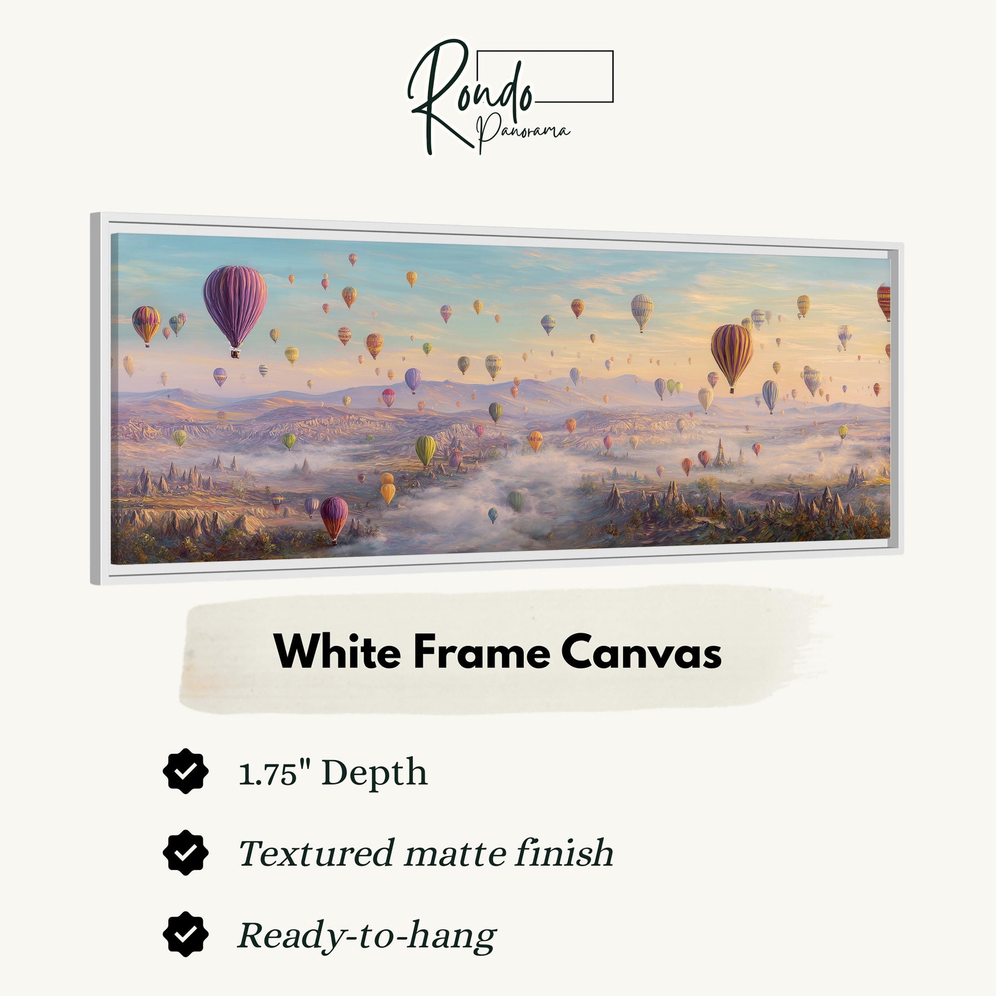A white frame canvas depicting a vibrant scene of hot air balloons floating over a mountainous landscape.