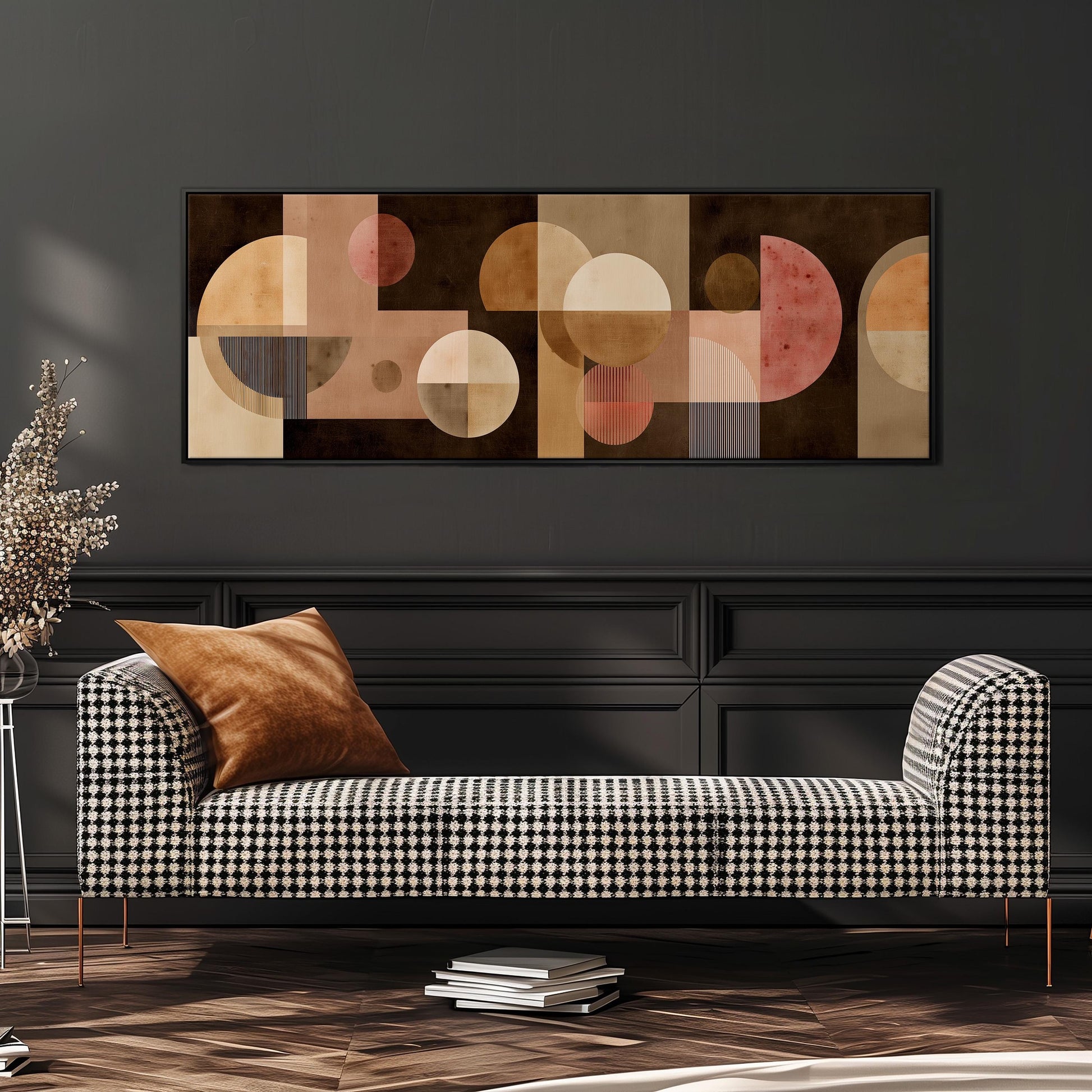 a modern living room with a black and white checkered sofa, a stack of books, and a large abstract painting on the wall above the sofa.