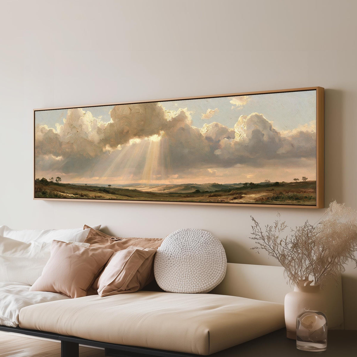 Sunbeams breaking through clouds over plains long horizontal canvas print above a sofa in a living room