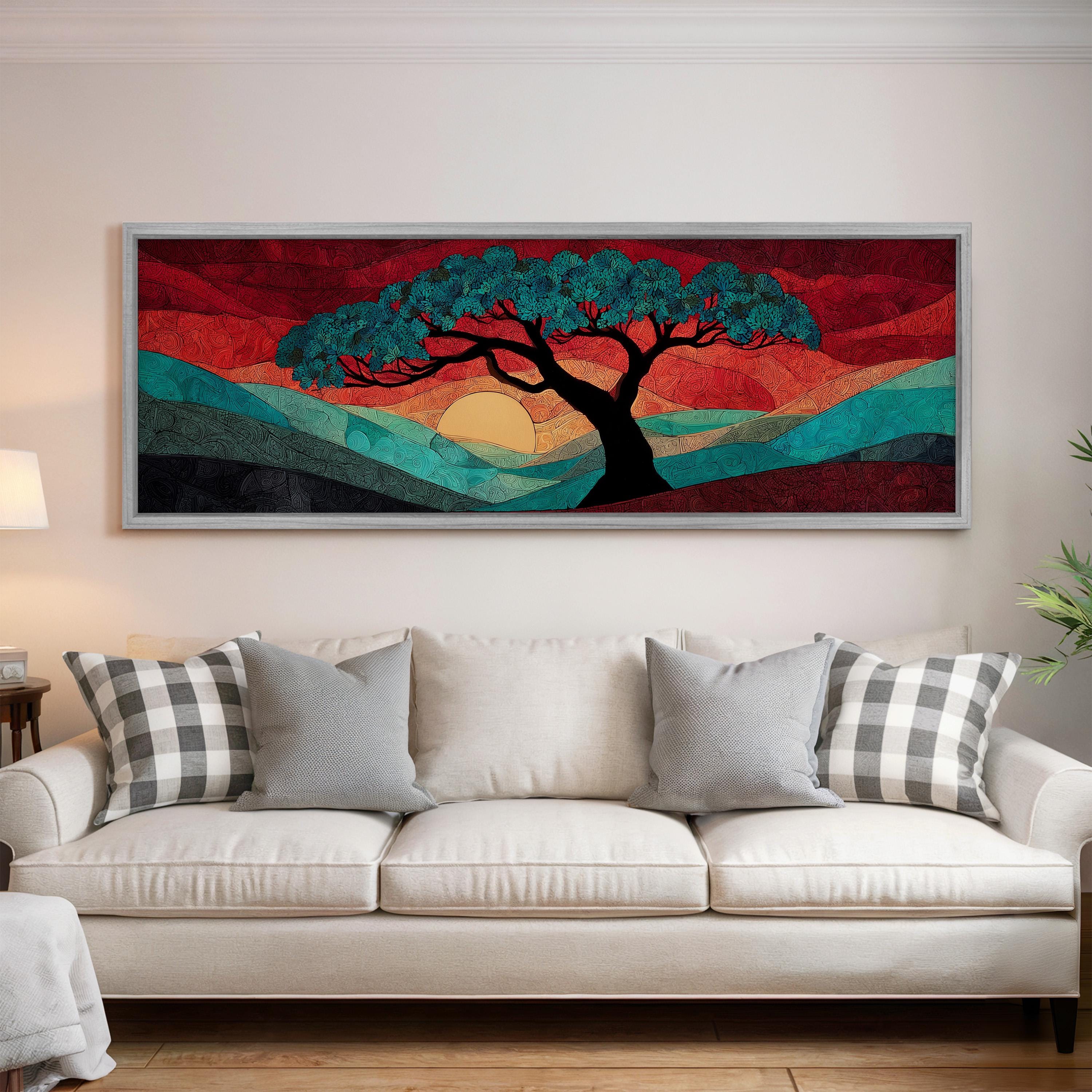 a large, colorful painting of a tree with a sunset in the background, hanging on a wall above a white couch with patterned pillows.