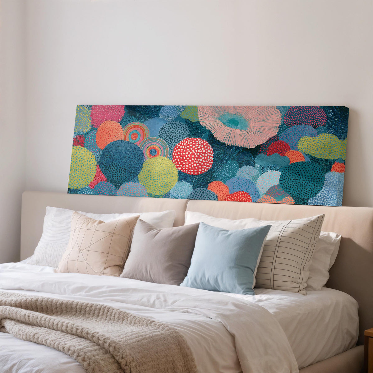 Coral spirals and dotted circles wide panoramic canvas print above a bed in a bedroom