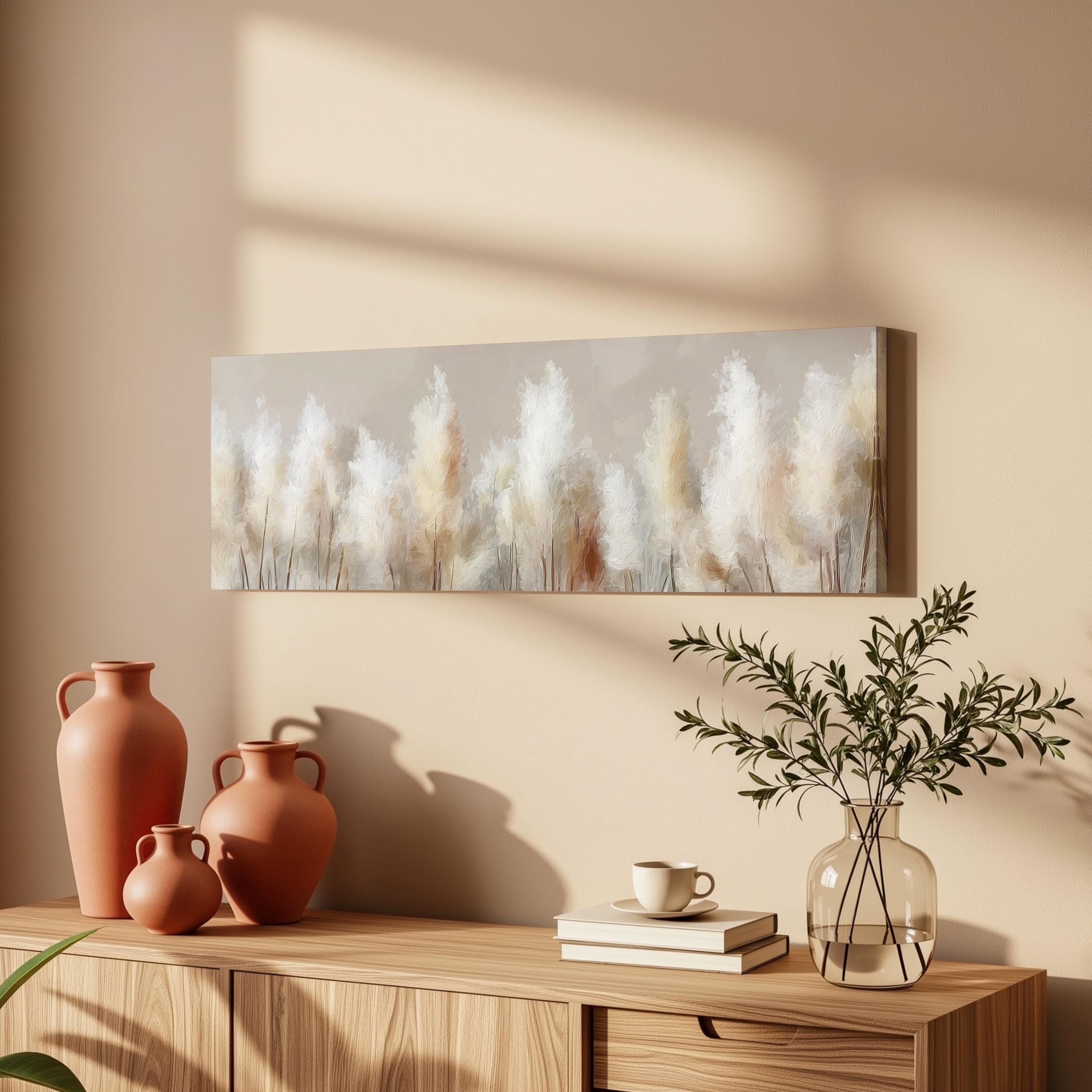 a wooden cabinet with a painting of white flowers hanging on the wall above it, along with three orange vases and a glass vase with greenery on the cabinet.