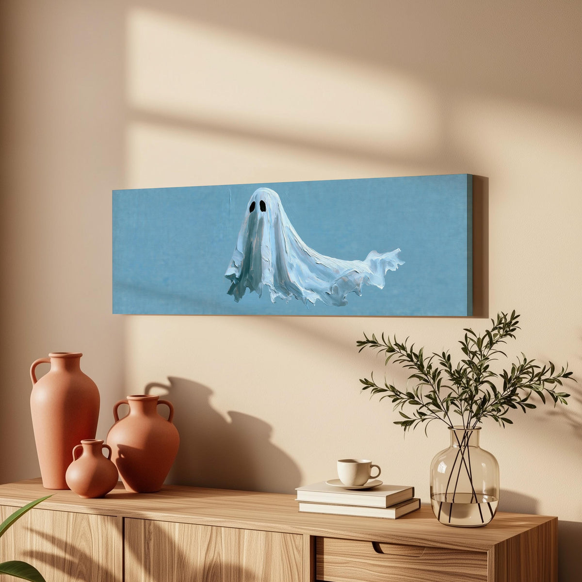 Floating ghost on blue long horizontal canvas print above a wooden sideboard