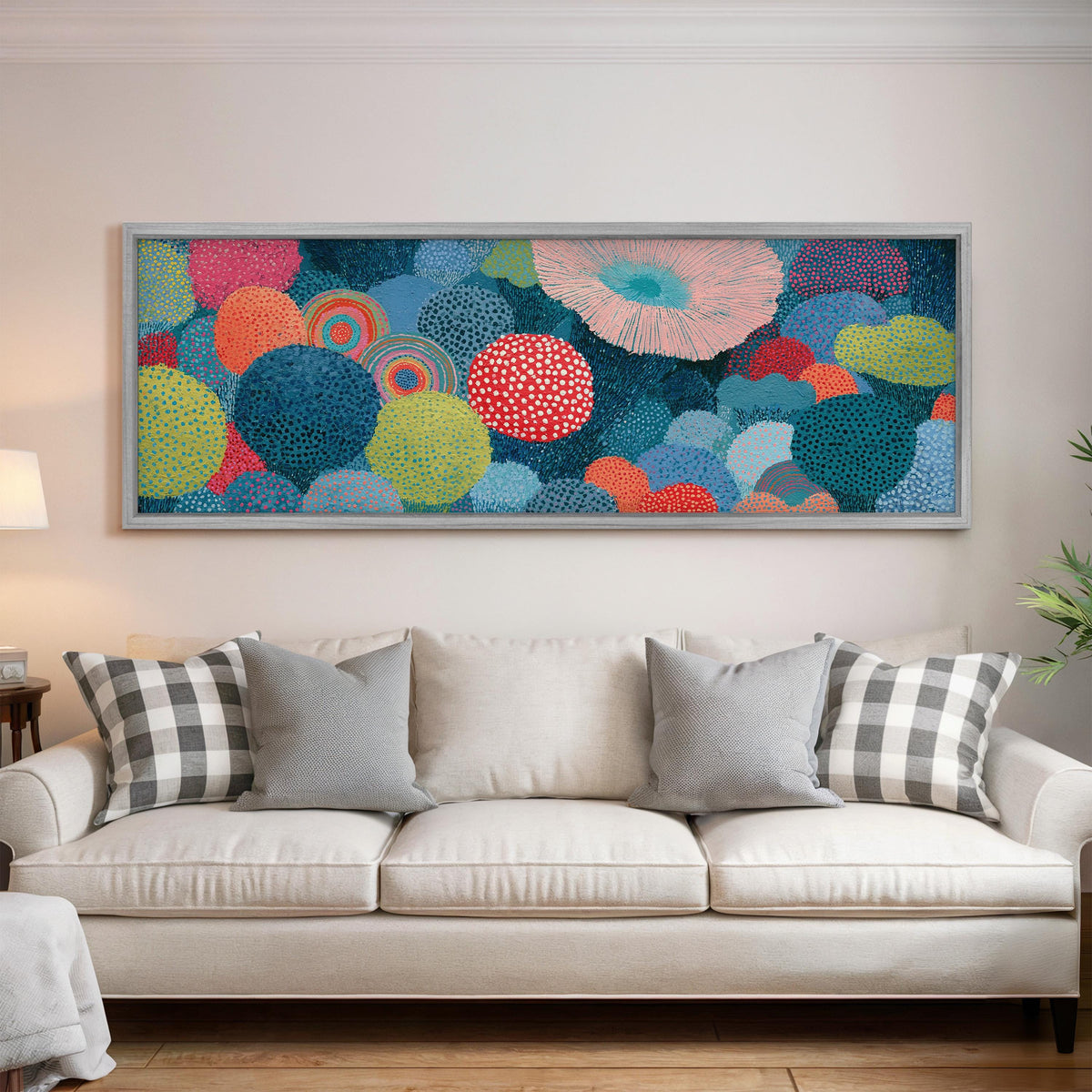 Coral spirals and dotted circles panoramic canvas print above a white sofa in a bright living room